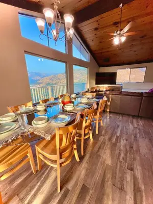 a dining room with a table and chairs with a view at Spacious sequoia Park retreat, best panoramic views in Three Rivers