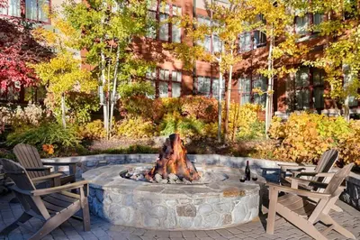 a fire pit in a courtyard with two chairs at Marriott Timber Lodge Luxury Studio in Stateline