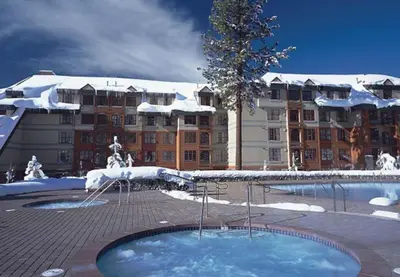 a large building with snow on top of a swimming pool at Marriott Timber Lodge Luxury Studio in Stateline