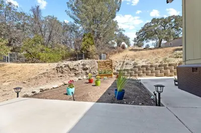 a garden with potted plants and a bench at Minutes from Sequoia Entrance in Three Rivers