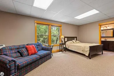 a living room with a couch and a bed at Sierra Haus Cottage with Private Lake Access in Sonora