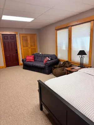 a room with a bed and a couch in a room at Sierra Haus Cottage with Private Lake Access in Sonora