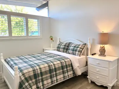 a bedroom with a white bed and a window at NEW cozy beautiful house with pool and hot tub in Fair Oaks