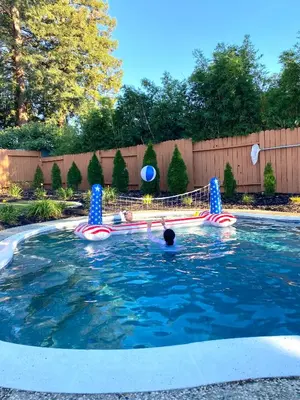 a pool with a water slide in a yard at NEW cozy beautiful house with pool and hot tub in Fair Oaks