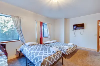 two beds in a room with two windows at Game Rooms, Sauna and Decks South Lake Tahoe Home in South Lake Tahoe