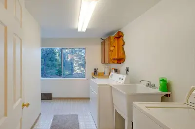 a white kitchen with a sink and a window at Game Rooms, Sauna and Decks South Lake Tahoe Home in South Lake Tahoe