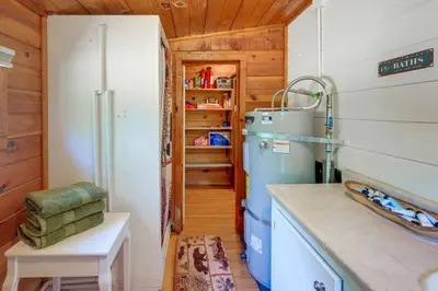a kitchen with a refrigerator and a table in a room at Rustic Cabin with Patio 8 Mi to Kings Canyon Park in Miramonte
