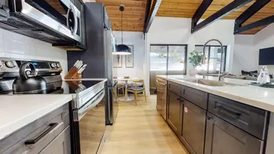 a kitchen with stainless steel appliances and wooden ceilings at Bigwood #96 condo in Mammoth Lakes
