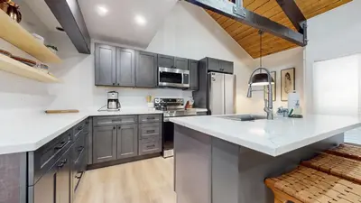 a kitchen with gray cabinets and a white counter top at Bigwood #96 condo in Mammoth Lakes
