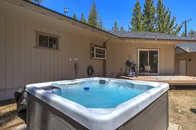 a large hot tub in front of a house at Adventure Awaits - Pets - Hot tub - Fire pit in Mevers