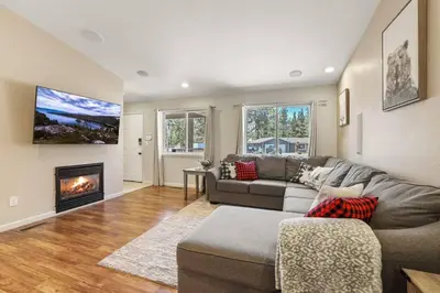 a living room with a couch and a fireplace at Adventure Awaits - Pets - Hot tub - Fire pit in Mevers