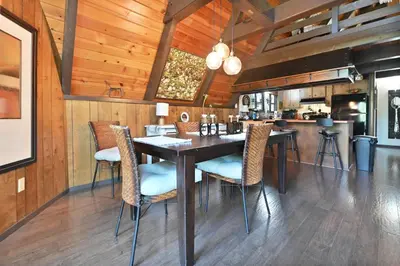 a dining room with a table and chairs at Hathaway Pines Hideaway Chalet in Hathaway Pines