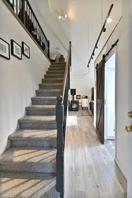 an open hallway with stairs in a house at Hathaway Hideaway Loft Apartment in Hathaway Pines