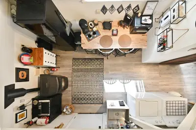 an aerial view of a kitchen and living room in a tiny house at Hathaway Hideaway Loft Apartment in Hathaway Pines