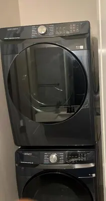 a black microwave oven sitting on top of a table at Cozy Retreat facing Western Park in Tracy