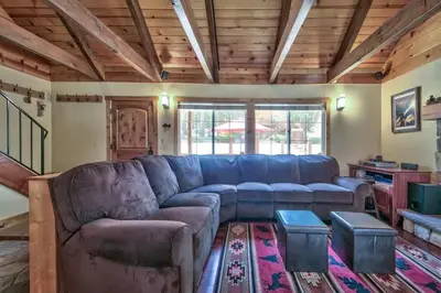 a living room with a blue couch in a house at Tahoe Townie - Cozy Cabin in South Lake Tahoe! in South Lake Tahoe