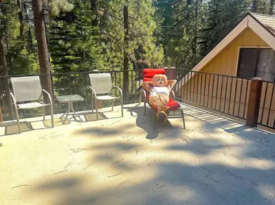 a teddy bear sitting in a chair on a deck at Tahoe Townie - Cozy Cabin in South Lake Tahoe! in South Lake Tahoe