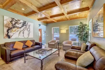 a living room with leather couches and a table at Elegant 6 Bed Sleeps 14 - Best for families w kids in South Lake Tahoe