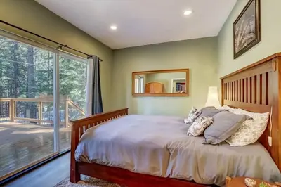a bedroom with a bed and a large window at Elegant 6 Bed Sleeps 14 - Best for families w kids in South Lake Tahoe