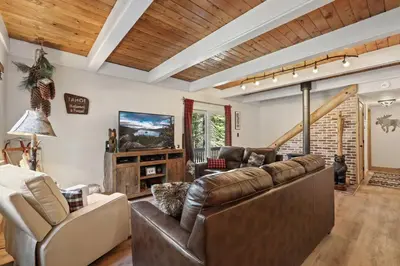 a living room with a leather couch and chairs at Moose Haven - Family Favorite! Close to beaches! in South Lake Tahoe