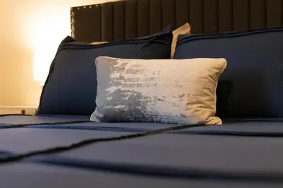 a bed with a pillow on top of it at Sequoia Zen River House in Three Rivers