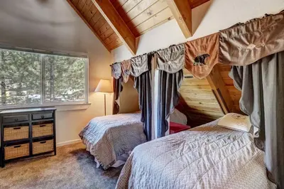 a bedroom with two beds and a window at Panorama Chalet - Hot tub - Pool Table - Snow in Nebelhorn