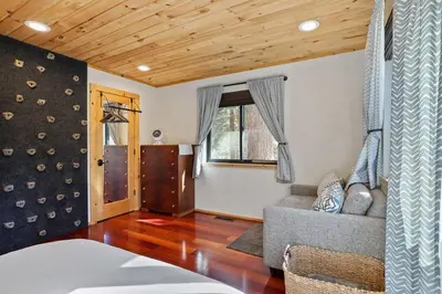 a living room with a couch and a window at Mountain Pine Memories - Dogs - Hot tub - E-bikes in South Lake Tahoe
