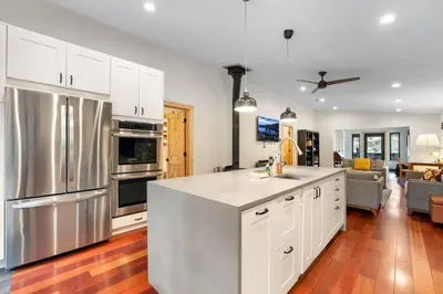a kitchen with white cabinets and stainless steel appliances at Mountain Pine Memories - Dogs - Hot tub - E-bikes in South Lake Tahoe
