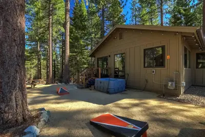 a building with a tent in the middle of a forest at Mountain Pine Memories - Dogs - Hot tub - E-bikes in South Lake Tahoe