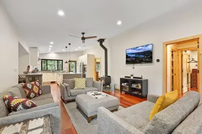 a living room with two couches and a tv at Mountain Pine Memories - Dogs - Hot tub - E-bikes in South Lake Tahoe