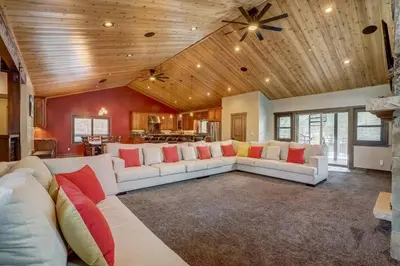 a living room with a white couch and red pillows at Chateau de Navahoe - Luxury - Hot tub - Large yard in South Lake Tahoe