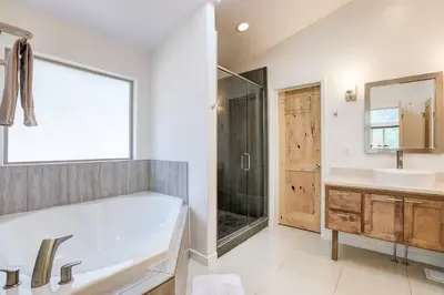 a bathroom with a tub and a sink and a shower at Sierra Solace - Forest & Seasonal River Out Back in South Lake Tahoe