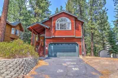 a wooden house with a garage at Tahoe Tranquility - Dogs - Hot tub - Ping Pong in South Lake Tahoe