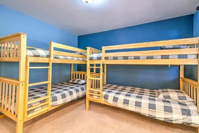 two bunk beds in a room with blue walls at Tahoe Tranquility - Dogs - Hot tub - Ping Pong in South Lake Tahoe