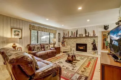 a living room with a couch and a fireplace at Bear Claw Trails - Dogs - Awesome Yard - Fire Pit in Lake Tahoe Airport