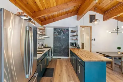 a kitchen with stainless steel appliances and wooden ceilings at Guadalupe Getaway - Pets - Hot Tub - AC in South Lake Tahoe