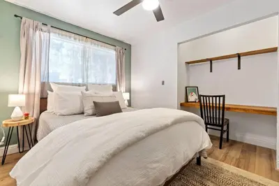 a bedroom with a large bed and a window at Guadalupe Getaway - Pets - Hot Tub - AC in South Lake Tahoe
