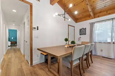 a dining room with a wooden table and chairs at Guadalupe Getaway - Pets - Hot Tub - AC in South Lake Tahoe