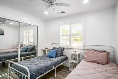 a bedroom with two beds and a mirror at Remodeled 1 Acre Ranch Home in Madera in Madera
