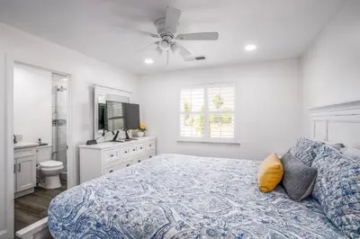 a white bedroom with a bed and a bathroom at Remodeled 1 Acre Ranch Home in Madera in Madera