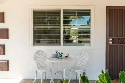 a table and three chairs in front of a window at Remodeled 1 Acre Ranch Home in Madera in Madera