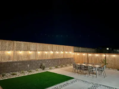a patio with a table and chairs and a fence at Spacious new house in Folsom Ranch 4BD and 3BA with backyard and BBQ grill in Folsom