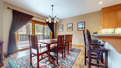 a kitchen and dining room with a table and chairs at Timbers #27 townhouse in Mammoth Lakes
