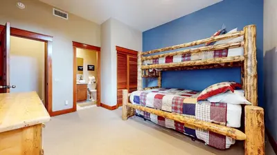 a bedroom with a wooden bunk bed in a room at Timbers #27 townhouse in Mammoth Lakes