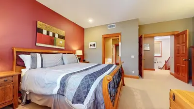 a bedroom with a large bed and red walls at Timbers #27 townhouse in Mammoth Lakes
