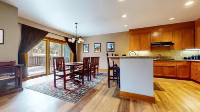 a kitchen and dining room with a table and chairs at Timbers #27 townhouse in Mammoth Lakes