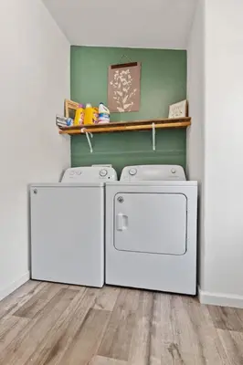 a laundry room with two dryers and a shelf at 10 Min Drive to the Sequoias in Three Rivers