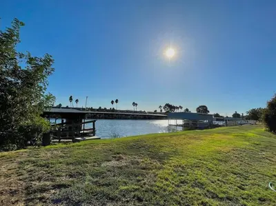 a body of water with a pier and the moon at Waterfront Home w 40x16 Berth in Bethel Island