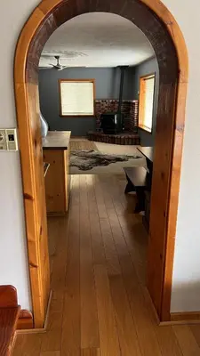 an archway in a room with a table and a desk at Mountain View Home in Kernville