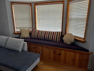 a window seat in a bedroom with pillows on it at Mountain View Home in Kernville